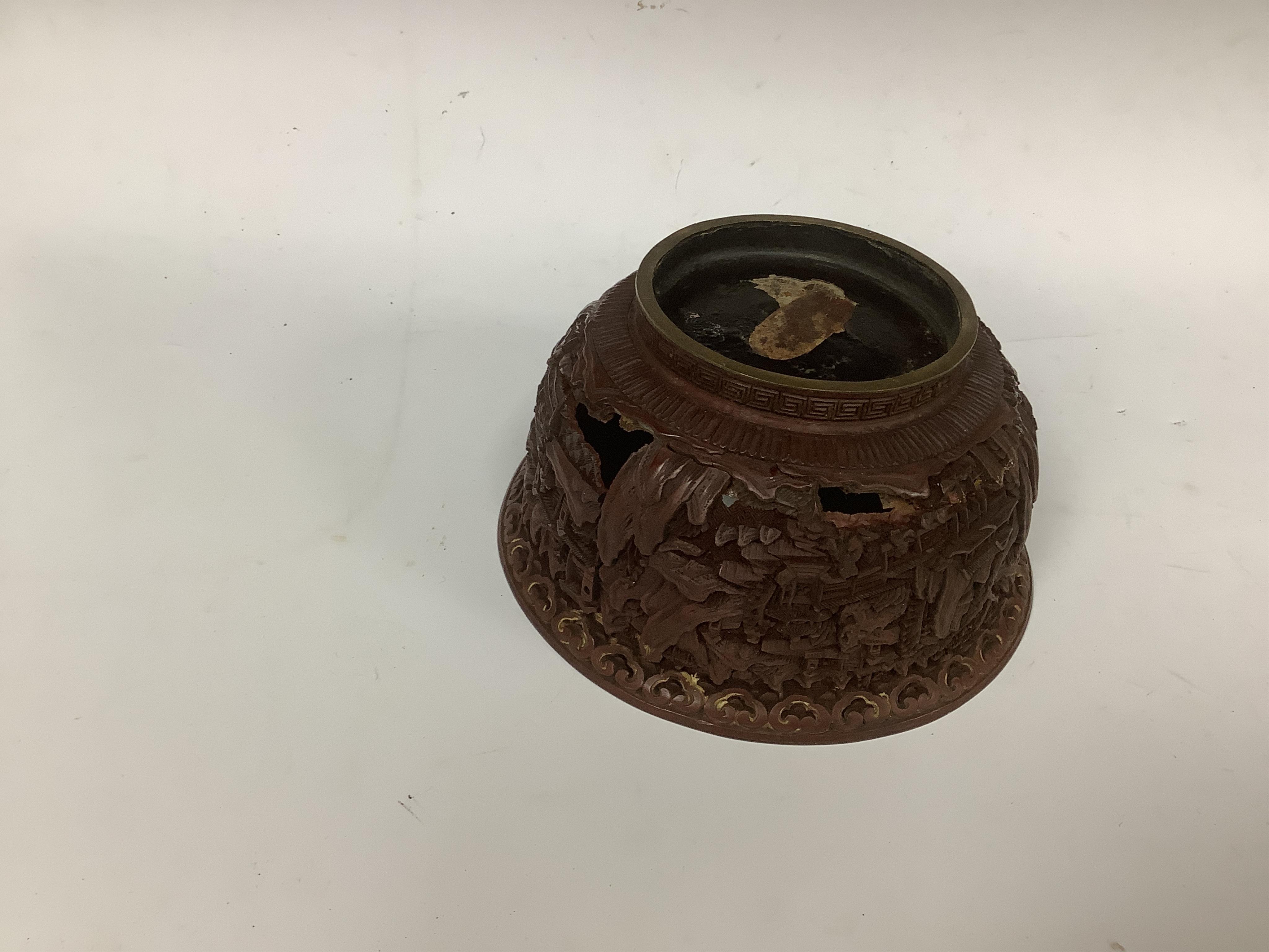 An 18th/19th century Chinese cinnabar lacquer bowl, on carved hongmu stand and a Chinese pierced brass disc. Condition - poor